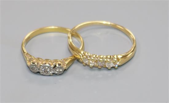 An 18ct gold and five stone diamond ring and an 18ct gold and illusion set three stone diamond ring.